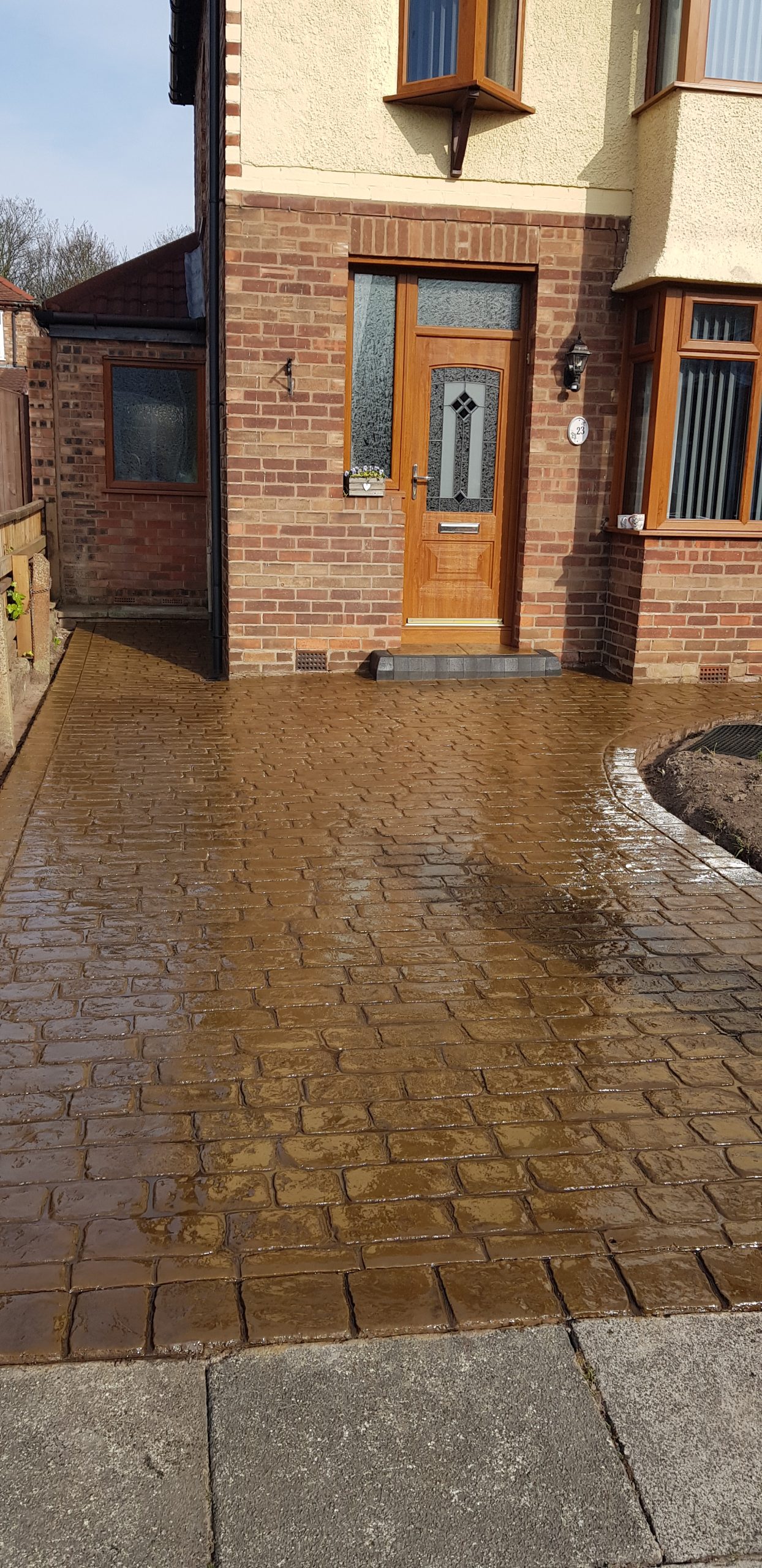 Brown cobbled poured concrete driveway